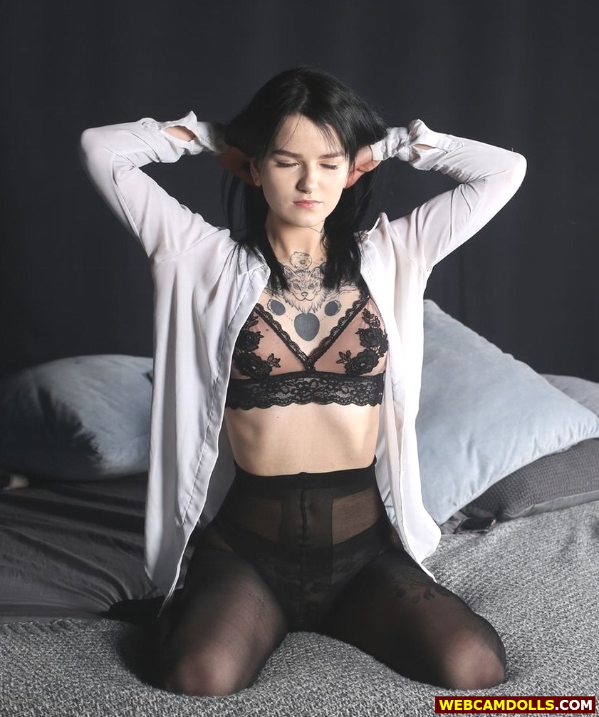 Black-Haired Tattooed Teen Girl wearing Black Sheer Tights and Nylon Lace Bra on Web Camdolls.com