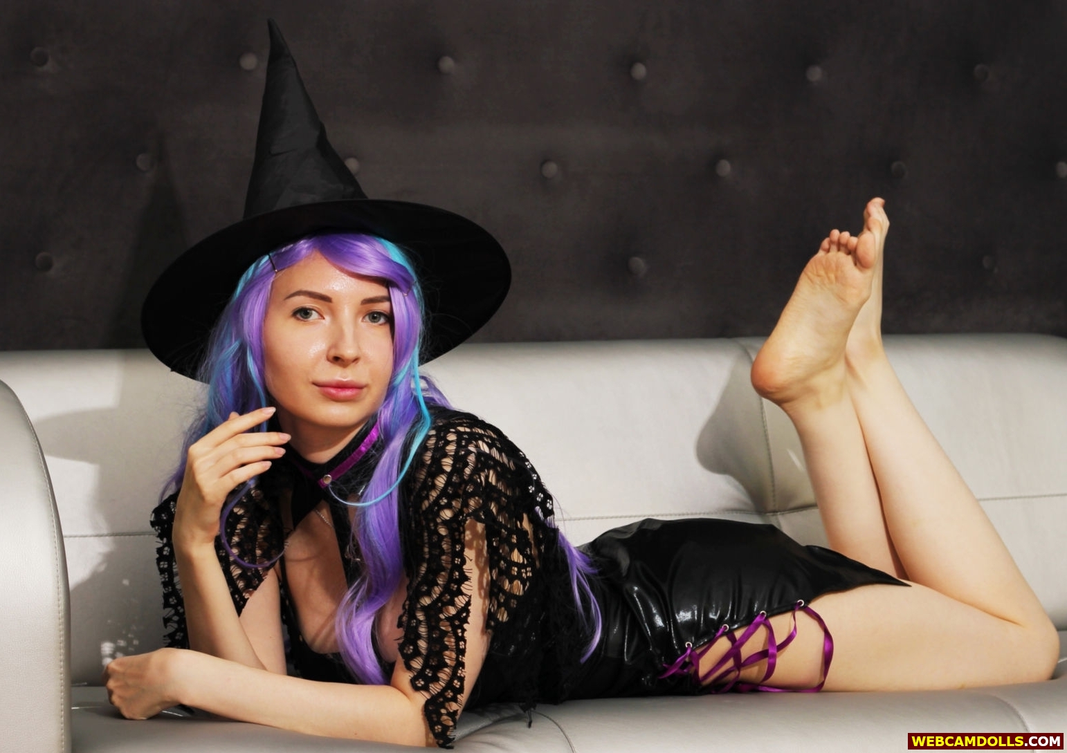 Purple Haired Witch showing Bare Feet Soles in Black Leather Mini Dress on Webcamdolls