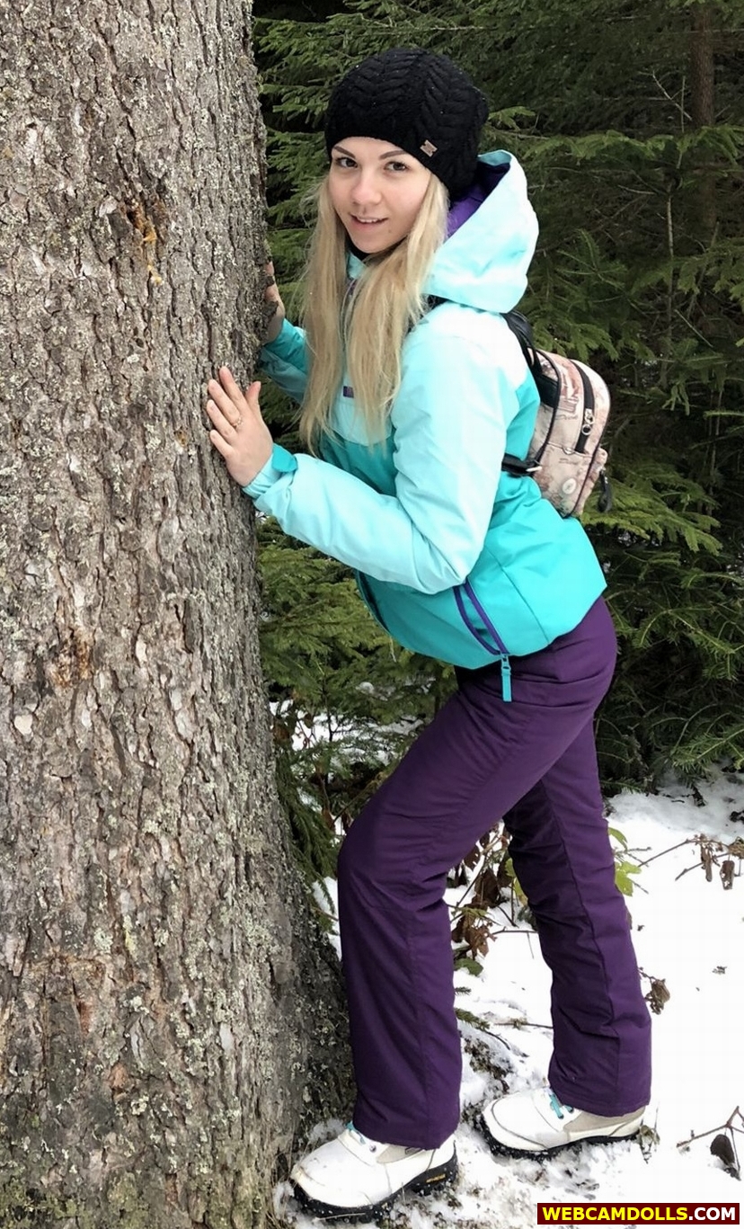 Blonde Girl in Purple Ski Suit and Green Anorak on Webcamdolls