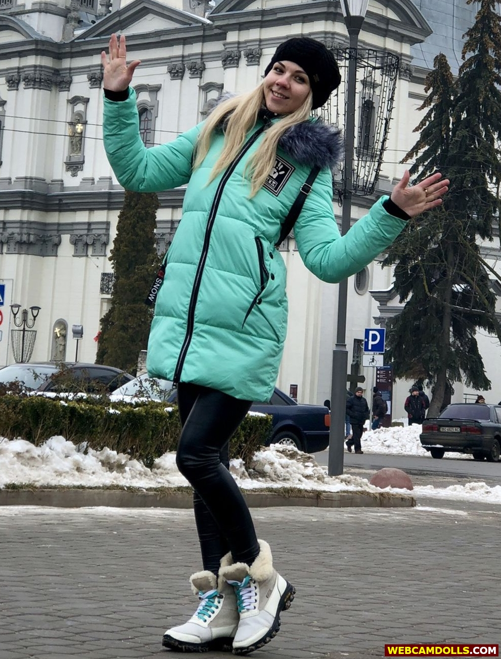 Blonde Girl wearing Black Ski Suit and Green Anorak on Webcamdolls